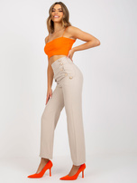 Beżowe eleganckie spodnie z materiału z kieszeniami