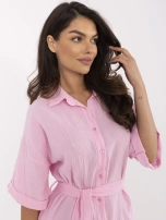Light pink short jumpsuit with button closure.