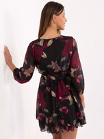 Black mini dress with a ruffle.