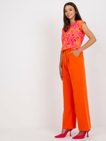 Pomarańczowe spodnie z materiału z szeroką nogawką