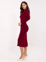 Burgundy knitted dress with decorative buttons.