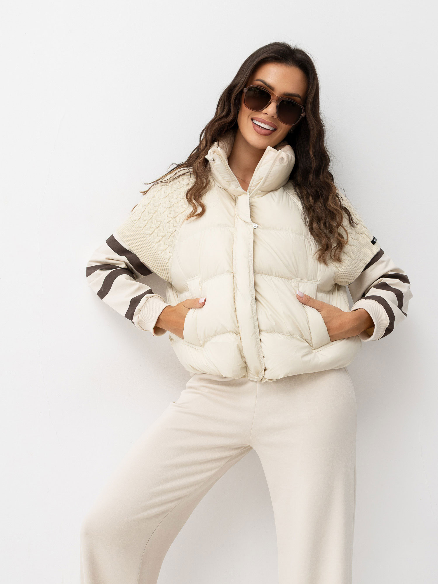 Light beige puffy vest with knitted inserts.
