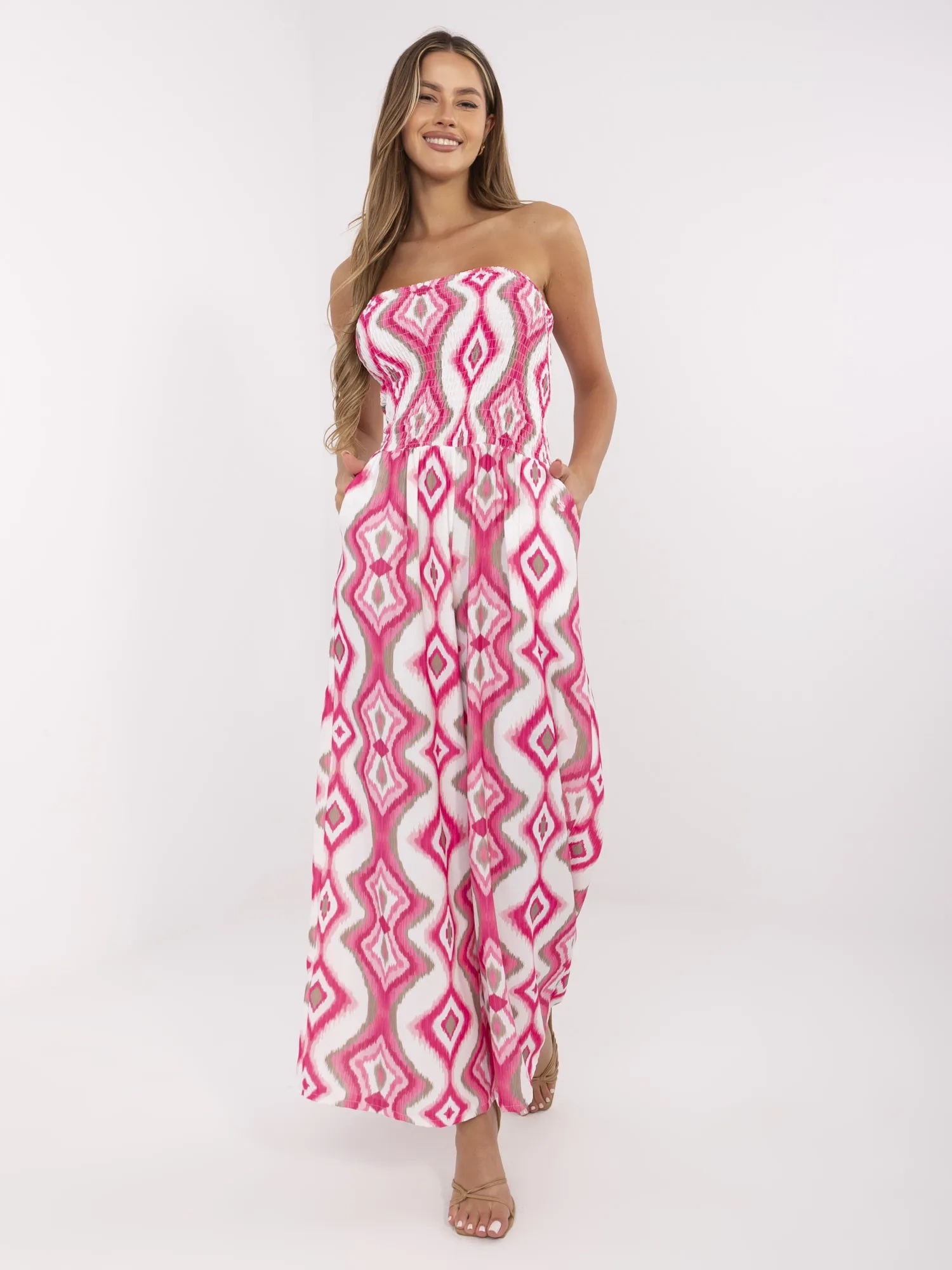 Pink and white jumpsuit with geometric patterns.