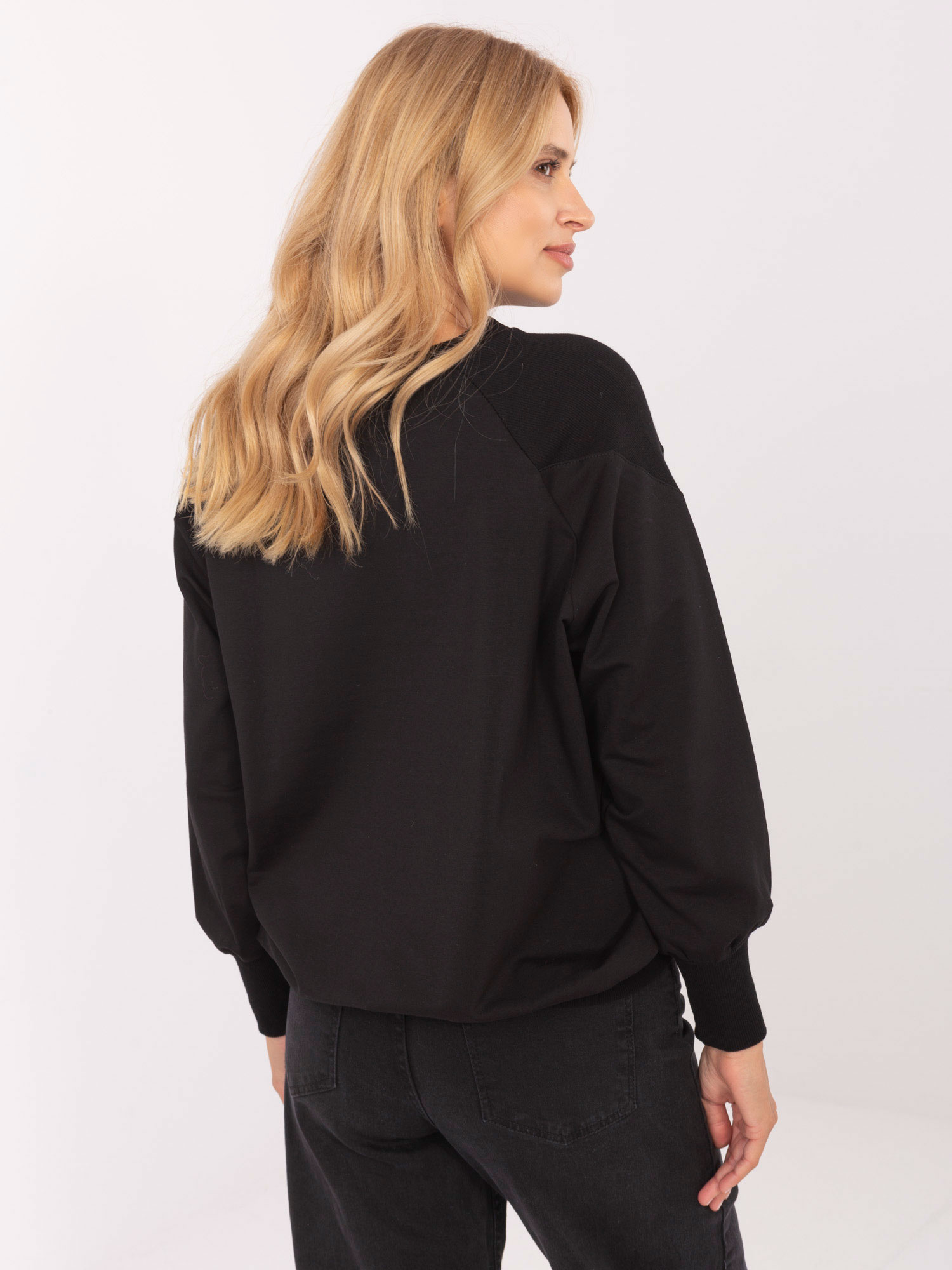 Black cotton blouse with an appliqué.