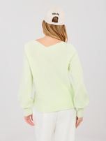 Pastellgrüner Pullover mit puffigen Ärmeln.