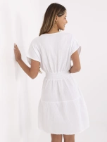 White muslin dress with a wrap neckline.