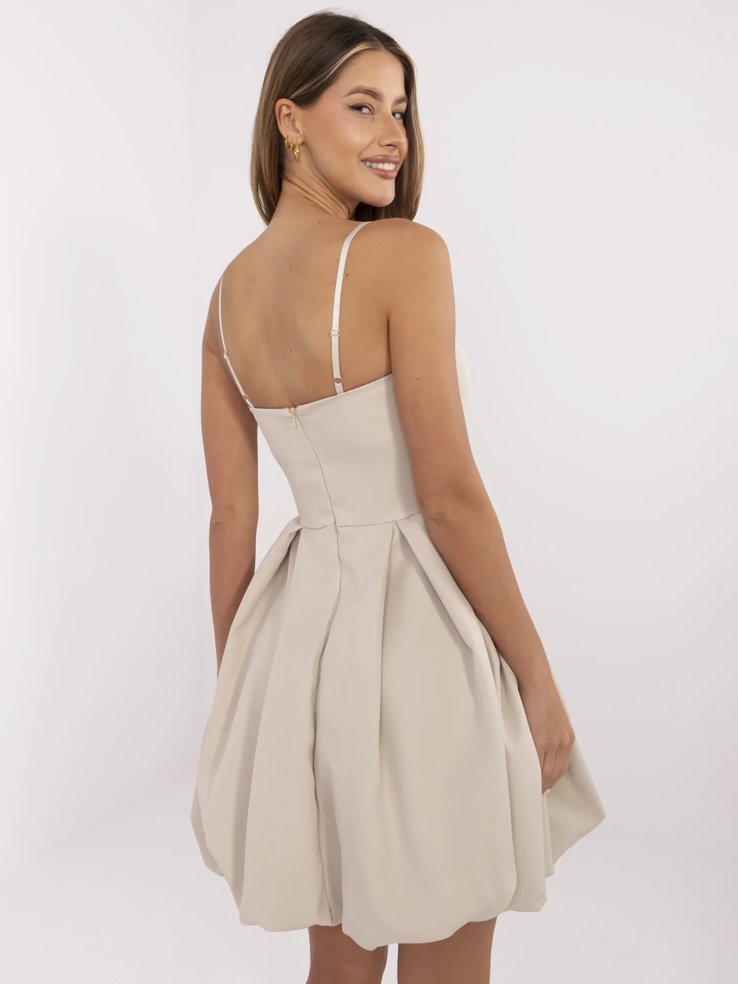 Beige short bubble dress with straps.