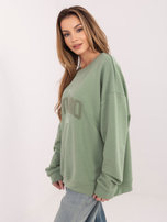 Pistacjowa bluza oversize z kontrastowym napisem 