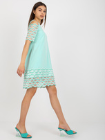 Hurt Mint cocktail dress with off-the-shoulder sleeves.