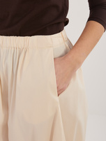 Jasnobeżowe spodnie parachute z kieszeniami RUE PARIS 