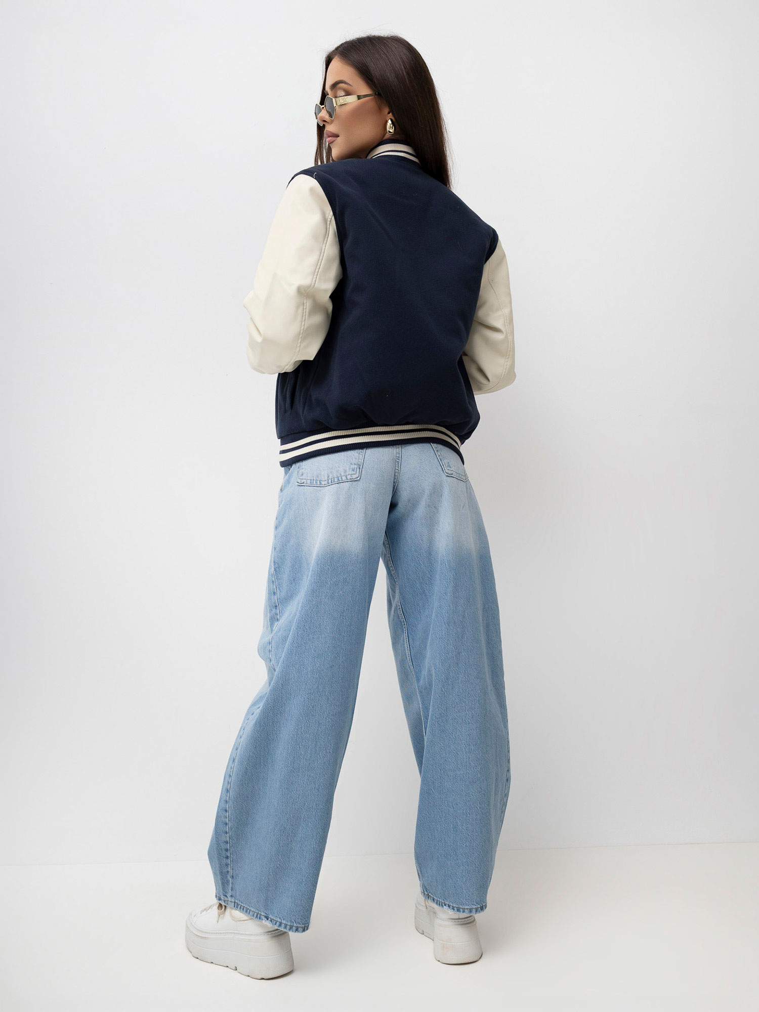 Navy blue insulated bomber jacket with patches.