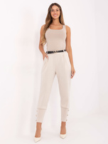 Jasnobeżowe dresowe spodnie z ozdobnymi guzikami