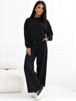 Black tracksuit set with shimmering rhinestones.