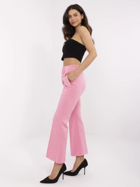 Różowe damskie spodnie z odpinanymi broszkami