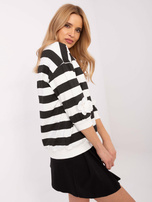 Wholesale black-ecru blouse with a round neckline.