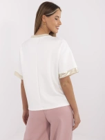 Ecru women's blouse with colorful print.