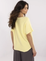 Light yellow reversible sweater with a V-neck.