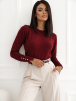 Bordeauxfarbener, taillierter Pullover mit goldenen Details.
