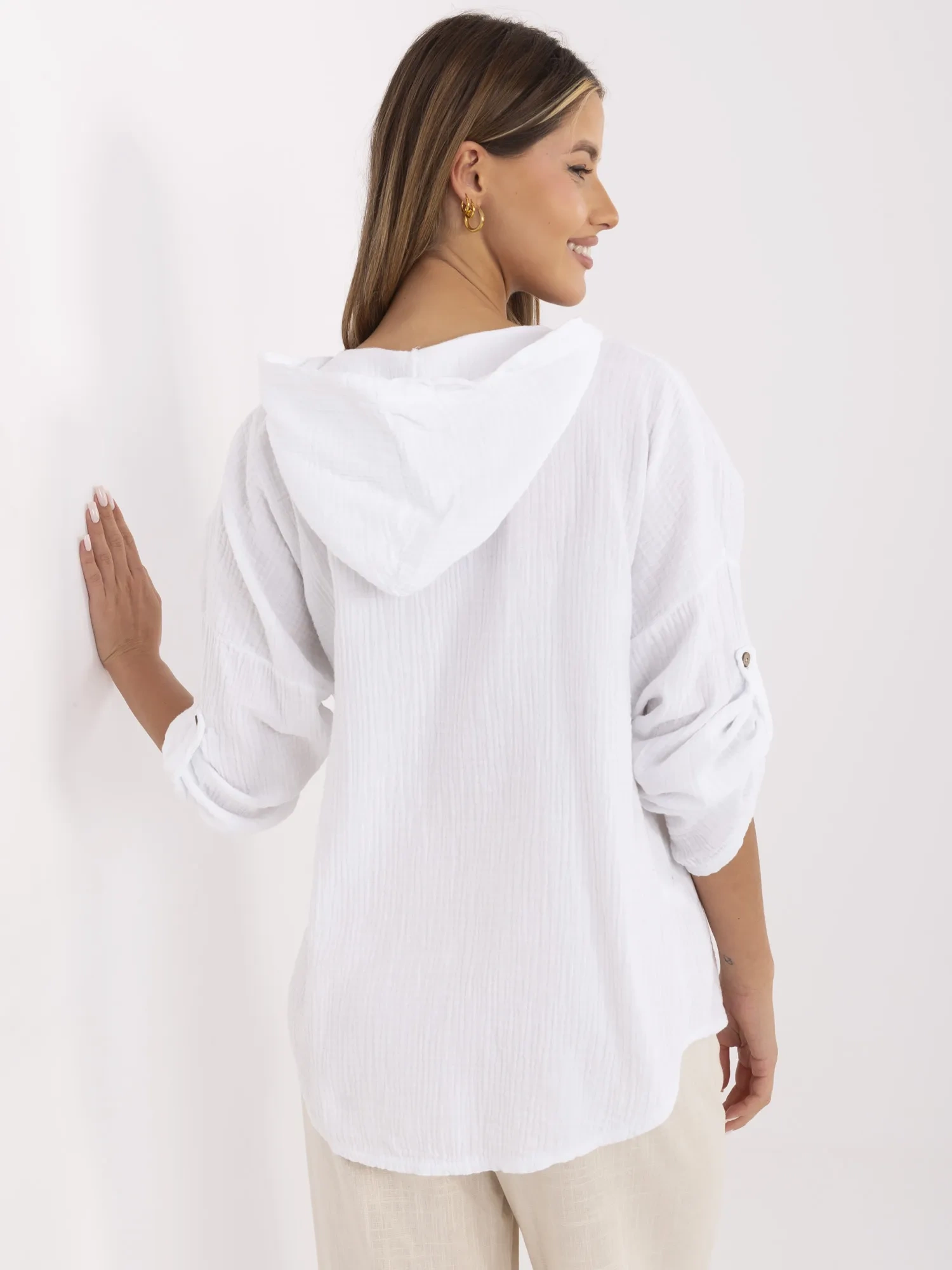 White muslin shirt with button closure.
