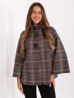 Light beige and black coat with large buttons.