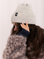 Light gray women's beanie hat with a heart patch.