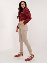 Hurt Beżowe połyskujące spodnie materiałowe z kieszeniami