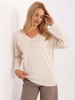 Jasnobeżowa bluzka oversize z długim rękawem