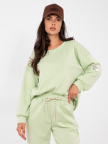 Pistazienfarbener Sweat-Anzug aus weichem Material.