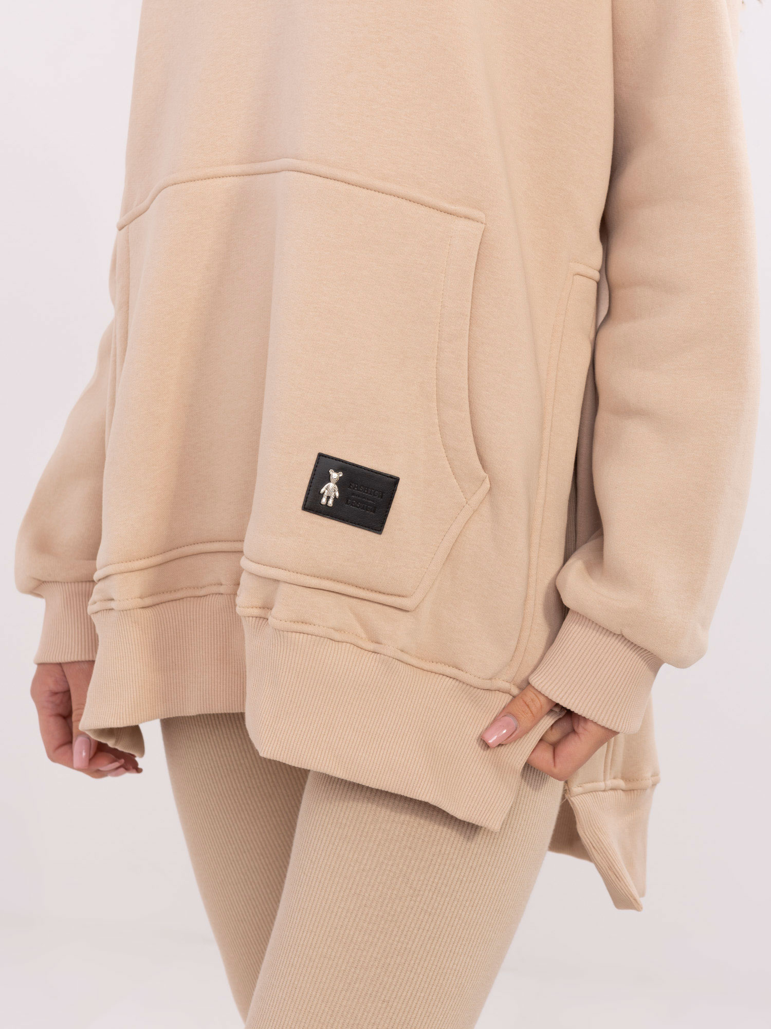 Beige three-piece set with a warm hoodie.