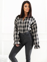 Black checkered shirt with ruffles at the sleeves.