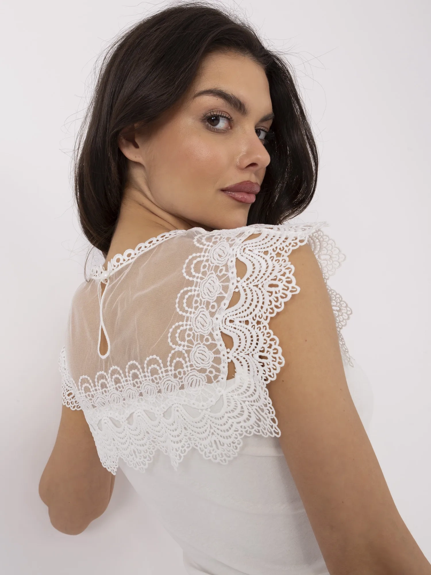 White fitted blouse with lace.