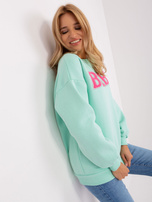 Mintgrüne Sweatshirt ohne Kapuze mit Aufschrift.