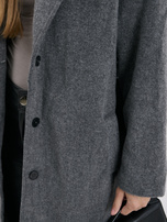 Dark gray oversized transitional coat with a belt.