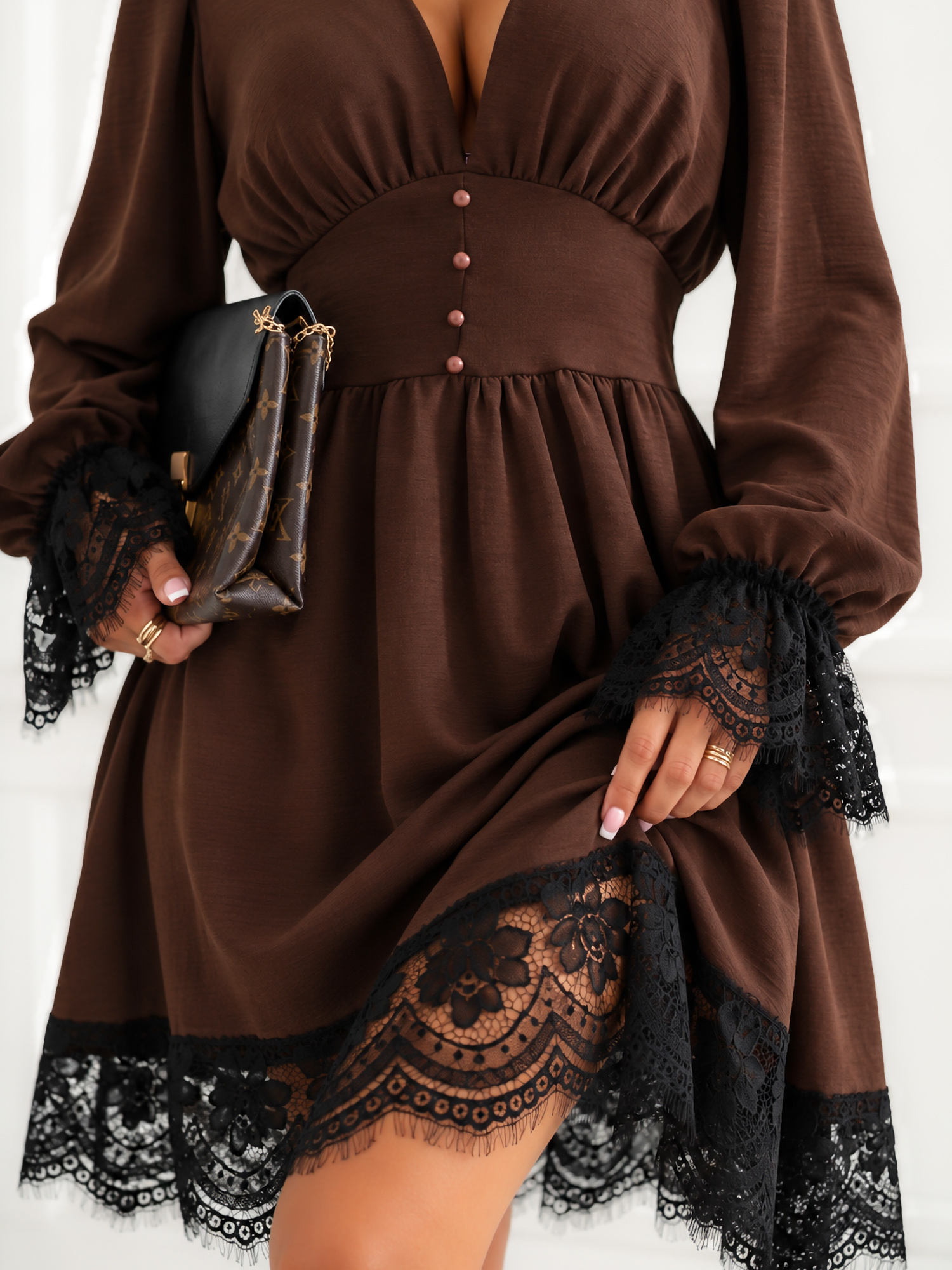 Brown dress with lace trim.