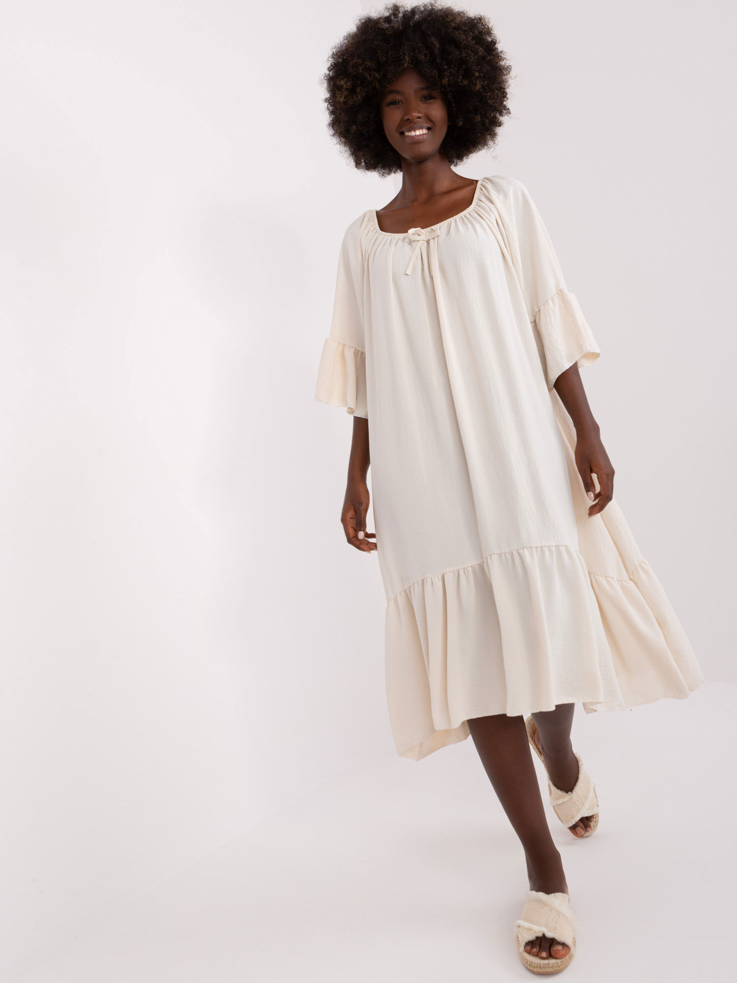 Hurt Light beige dress with a ruffle and 3/4 sleeve.