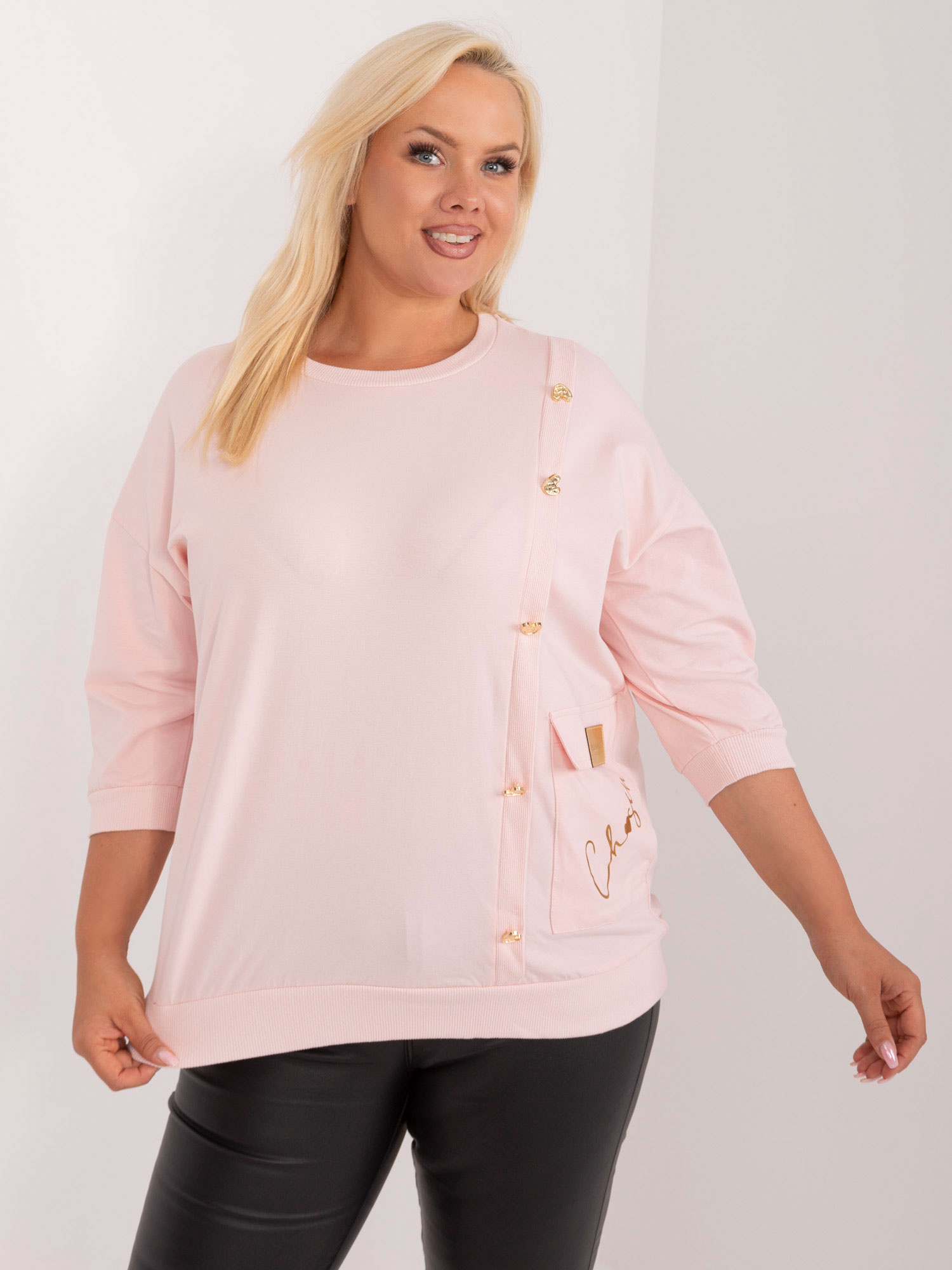 Light pink plus size blouse with an application and inscription.