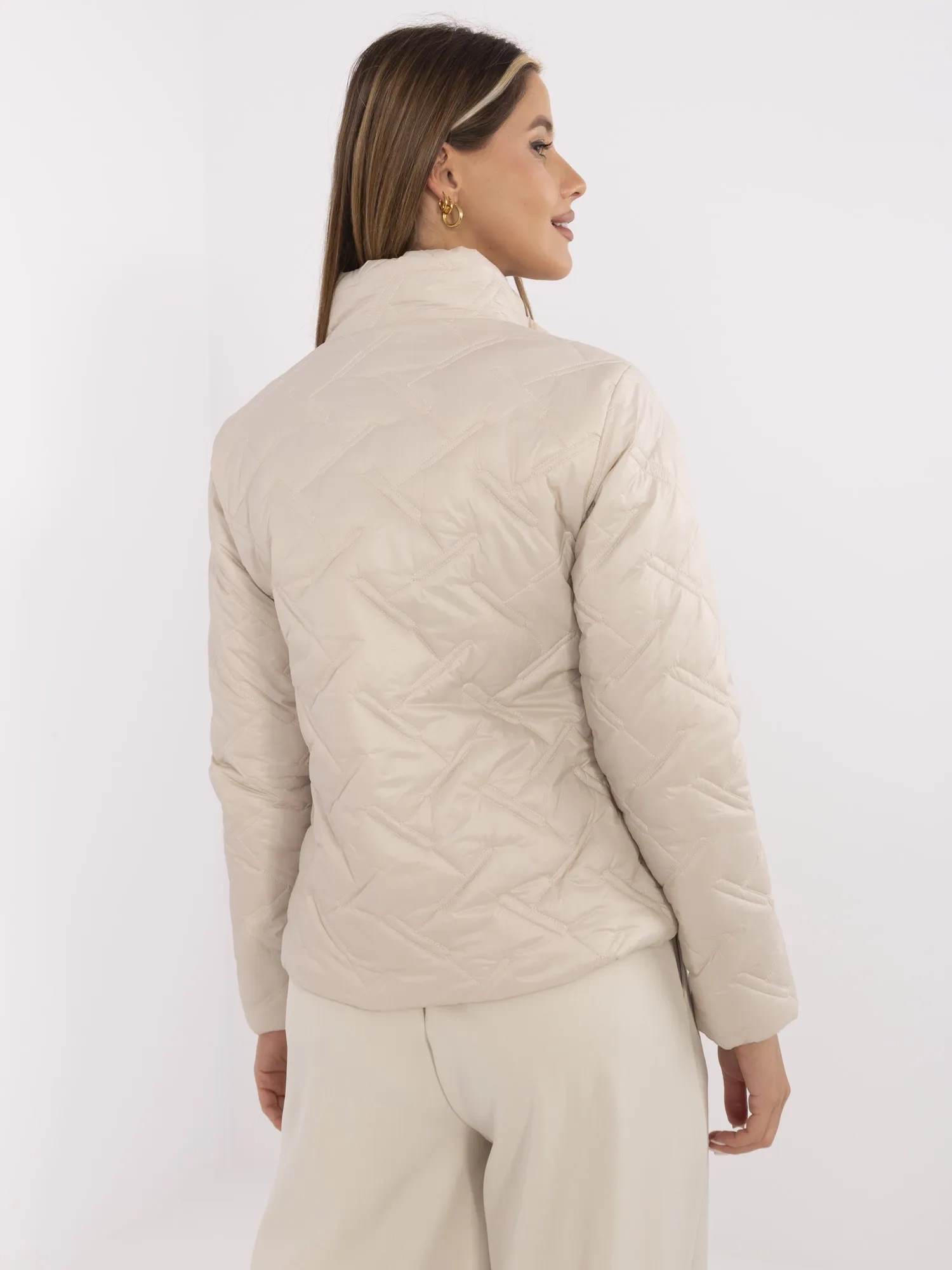 Beige quilted women's jacket with a stand-up collar.