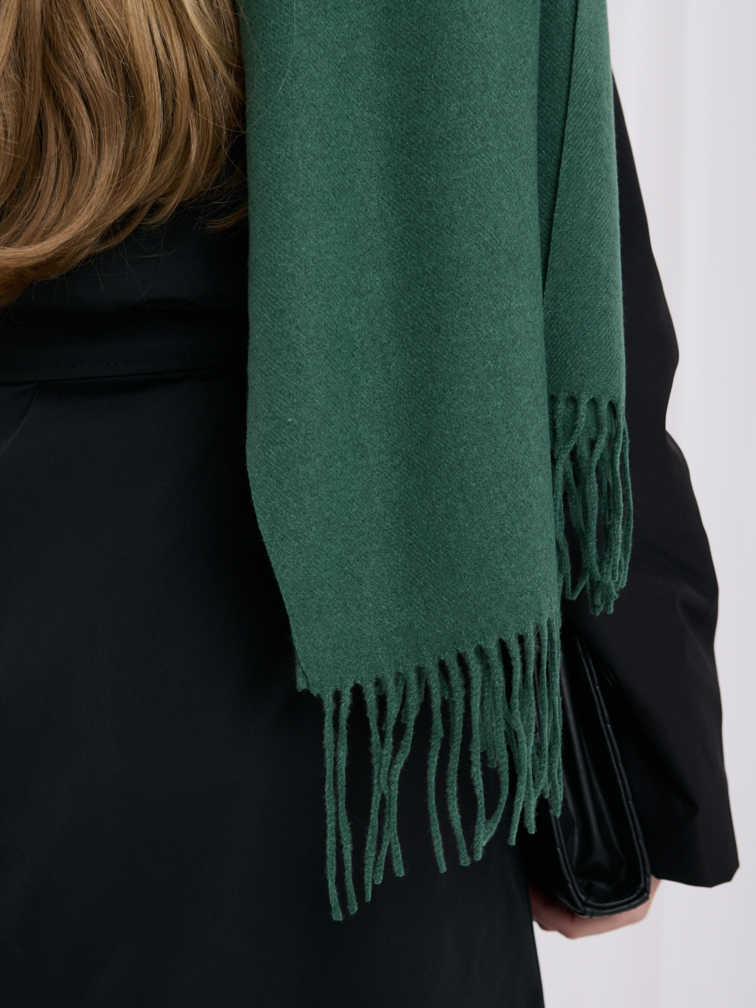Dark green smooth scarf with fringes.