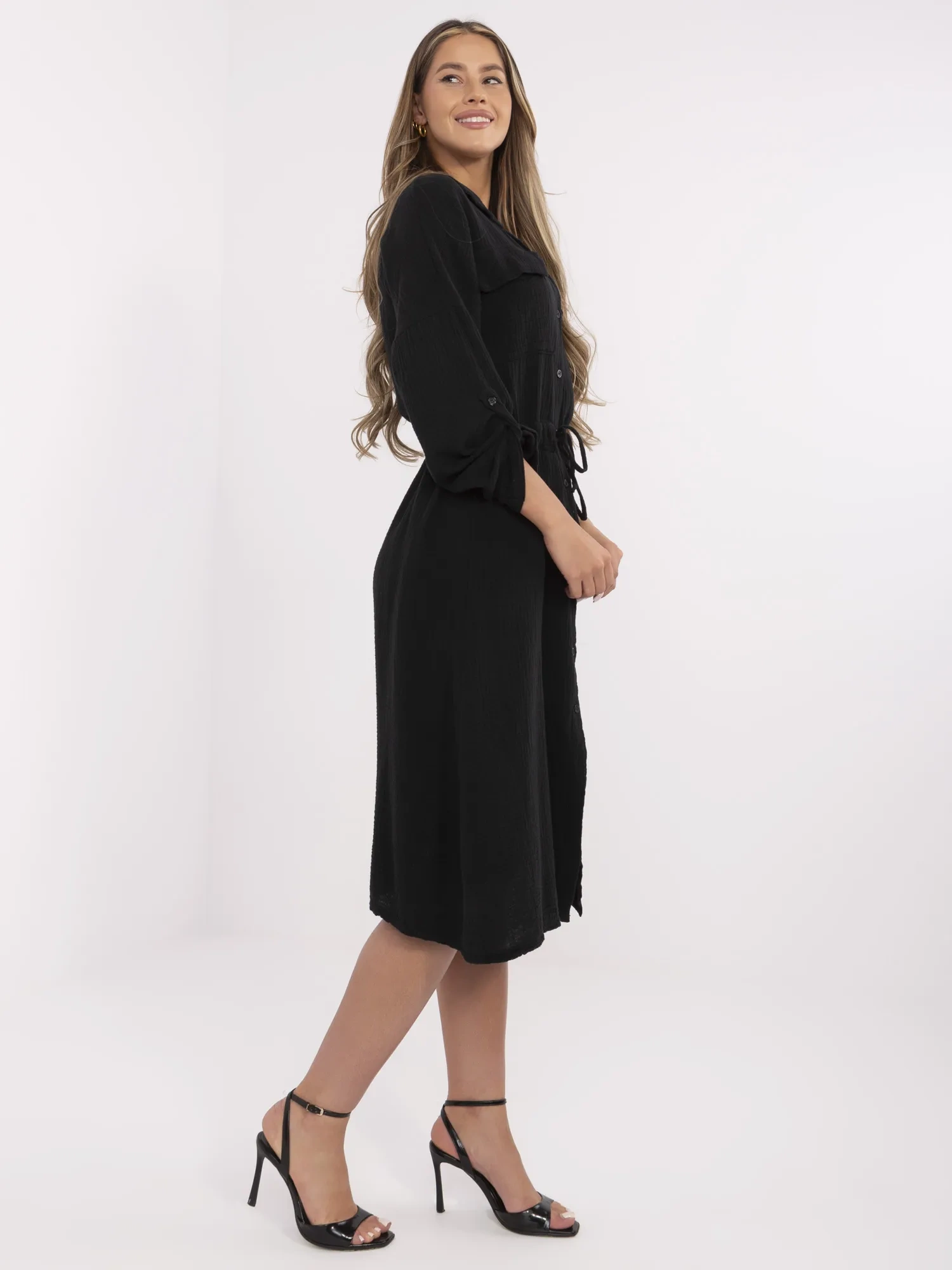 Black muslin dress with a drawstring at the waist.
