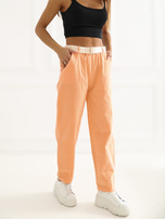 Jasnopomarańczowe sztruksowe spodnie z kieszeniami