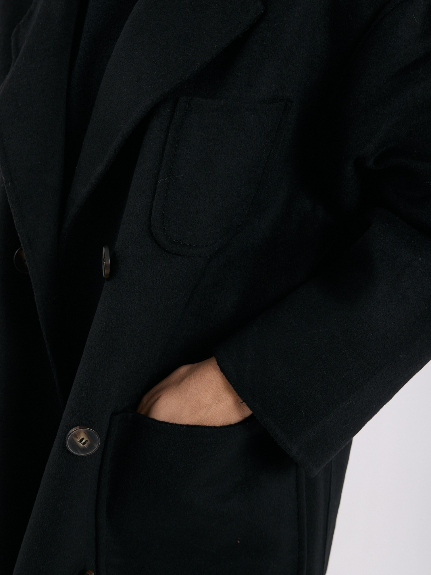 Black double-breasted coat with a wool blend.
