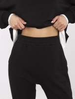 Black tracksuit set with a hoodless sweatshirt.