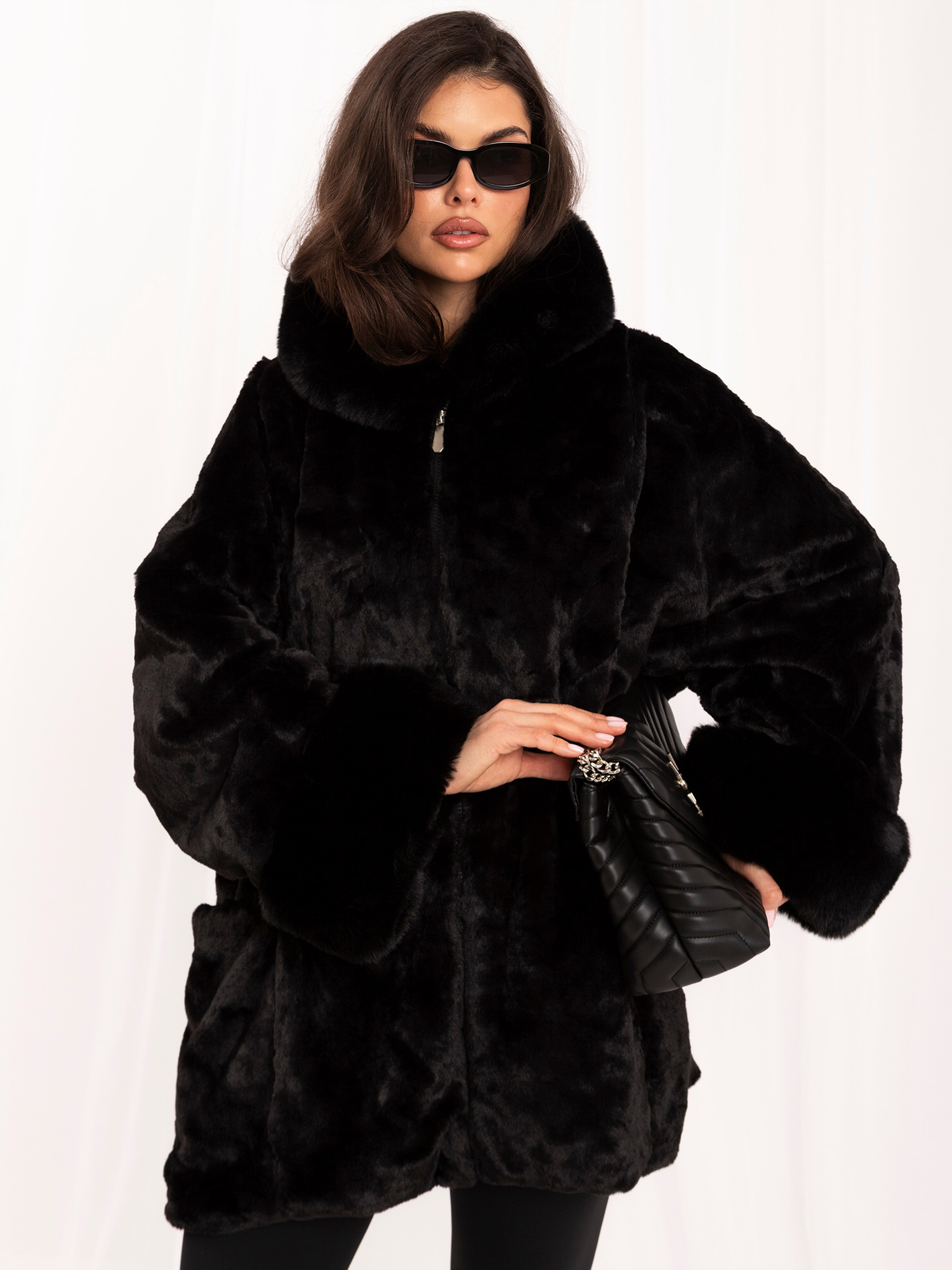 Schwarze Damenfelljacke mit auffälligen Ärmeln.