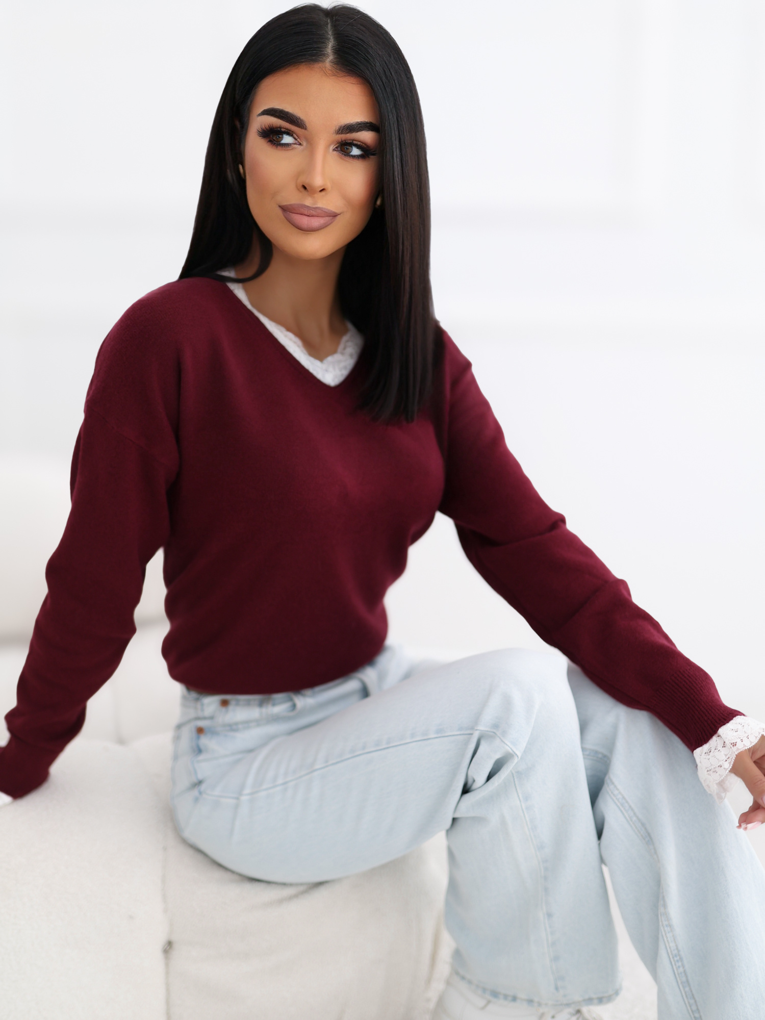 Burgundy sweater with decorative lace trim.
