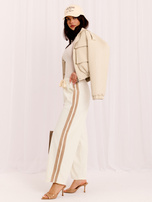Ecru corduroy pants with stripes.