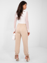 Beżowe dresowe spodnie ze ściągaczami 