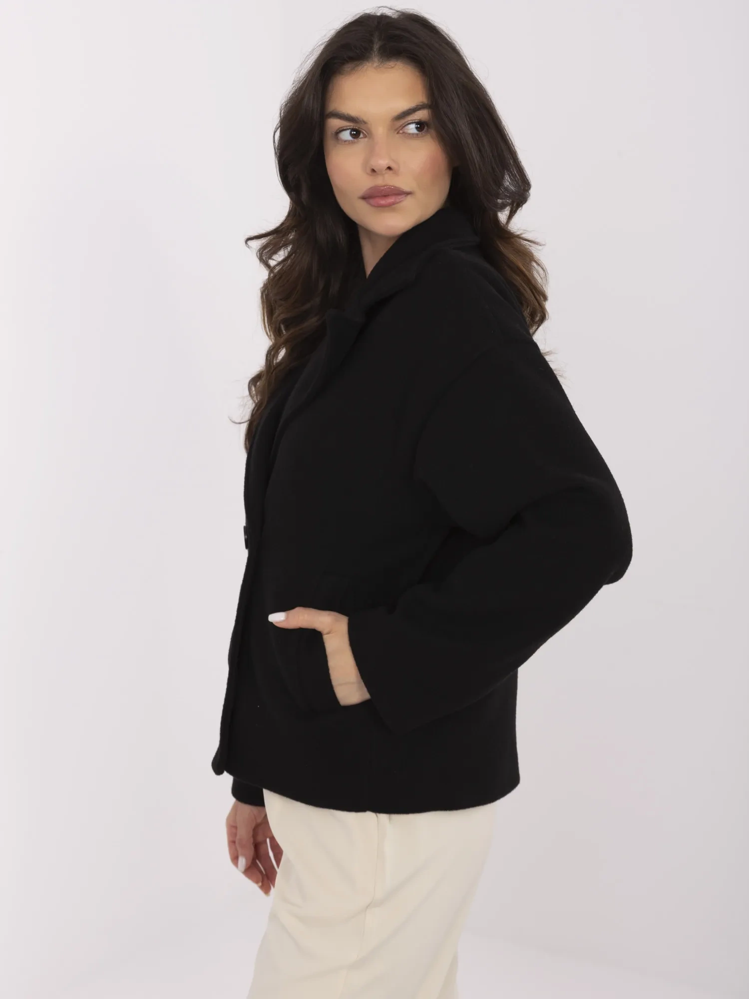 Black short coat with double-breasted fastening.