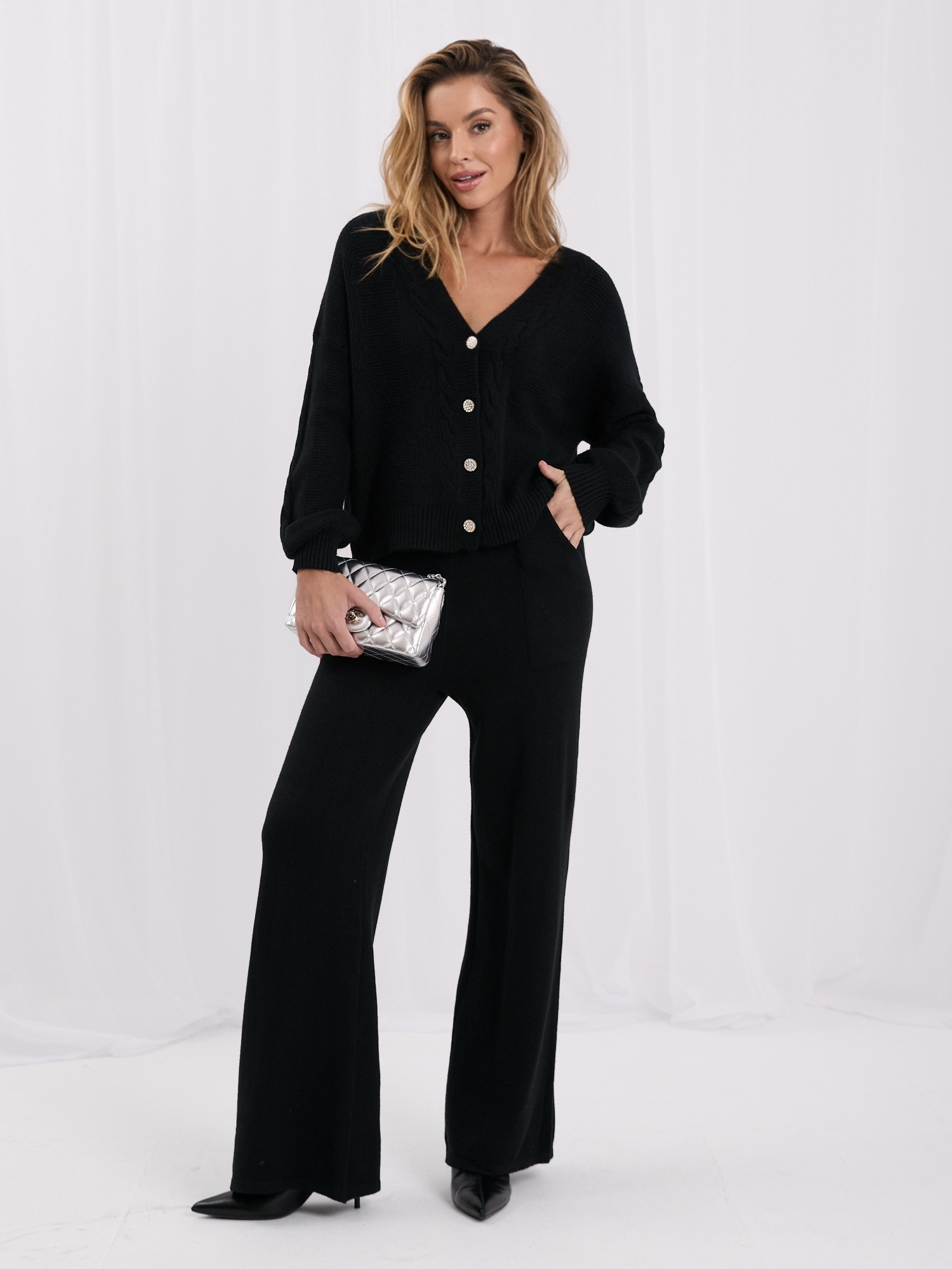 Black sweater set with wide pants.
