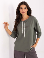 Khaki women's blouse with embroidered writing.