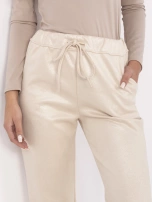 Hurtownia Beżowe zwężane spodnie z połyskiem